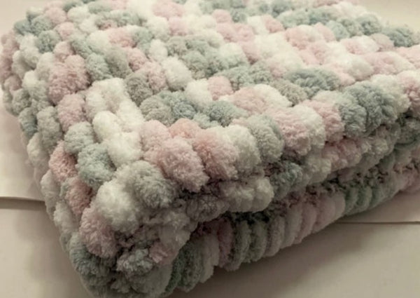 Hand knitted, pink grey and white, pom pom wool pram cover.