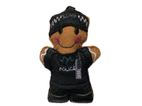 Police officer gingerbread decoration in black uniform stab vest, on white background.
