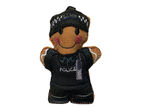 Police officer gingerbread decoration in black uniform stab vest, on white background.