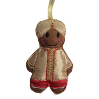 Decorative gingerbread man ornament with a turban on a white background