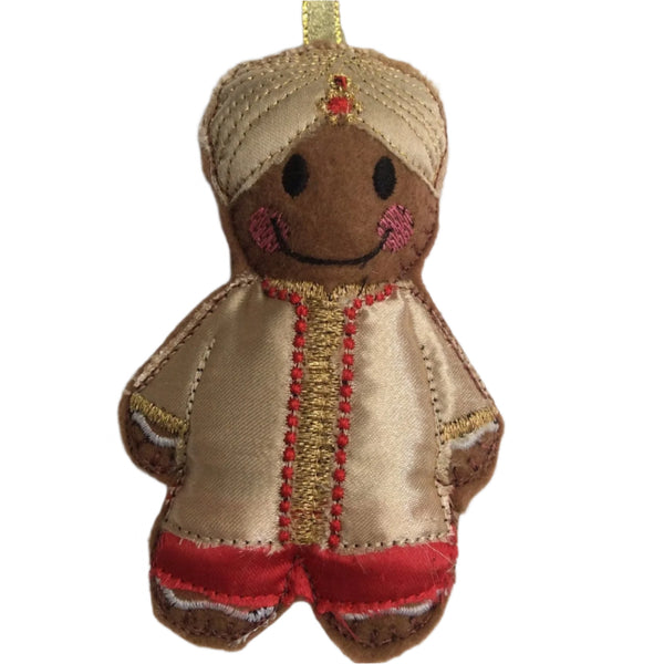 A gingerbread man decoration dressed in traditional Indian attire, with a gold-colored turban and brown body, designed as a hanging ornament.