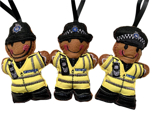 British Transport Police Officer felt gingerbread decorations, showing cap, helmet or female officer decorations on white background.