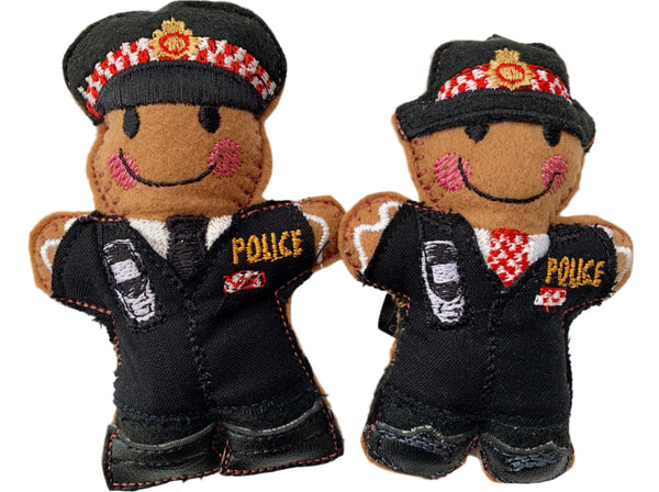 Two gingerbread Christmas decorations dressed as City of London police officers on a white background