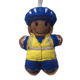 Coastguard gingerbread man Christmas decoration. Dressed in blue uniform and hat with yellow hi viz vest. On white background.