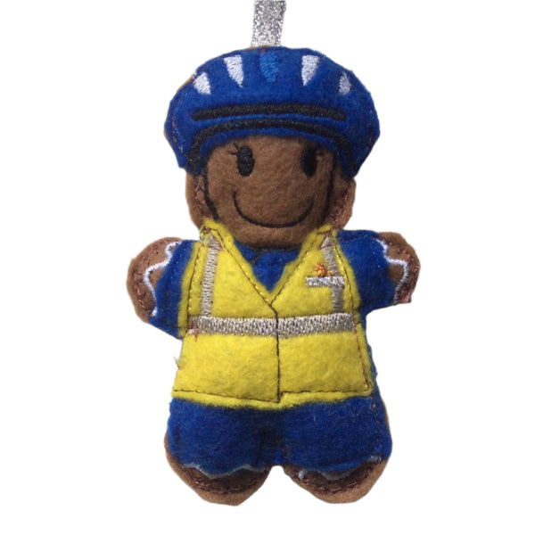 Coastguard gingerbread man Christmas decoration. Dressed in blue uniform and hat with yellow hi viz vest. On white background.