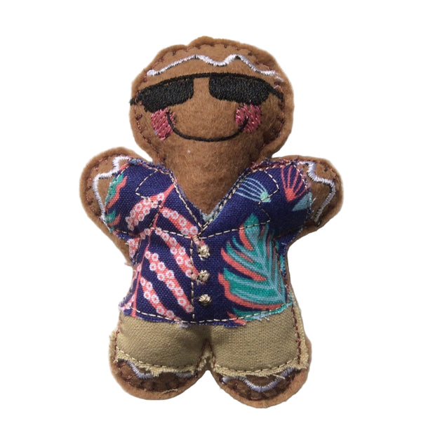 A felt gingerbread man decoration dressed in a blue Hawaiian shirt, beige shorts and sunglasses. Designed as a Christmas tree ornament.