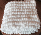 Pom pom blanket knitted.