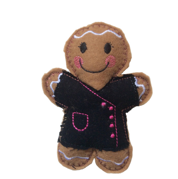 Beautician felt gingerbread decoration. Dressed in a black cotton tunic with pink buttons and decorative finish. Lightly filled with a polyester filling to create depth and character. Hand sewn to finish.