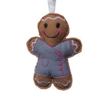 Beautician felt gingerbread decoration. Dressed in grey cotton tunic with pink buttons and decorative finish. Lightly filled with a polyester filling to create depth and character. Hand sewn to finish.