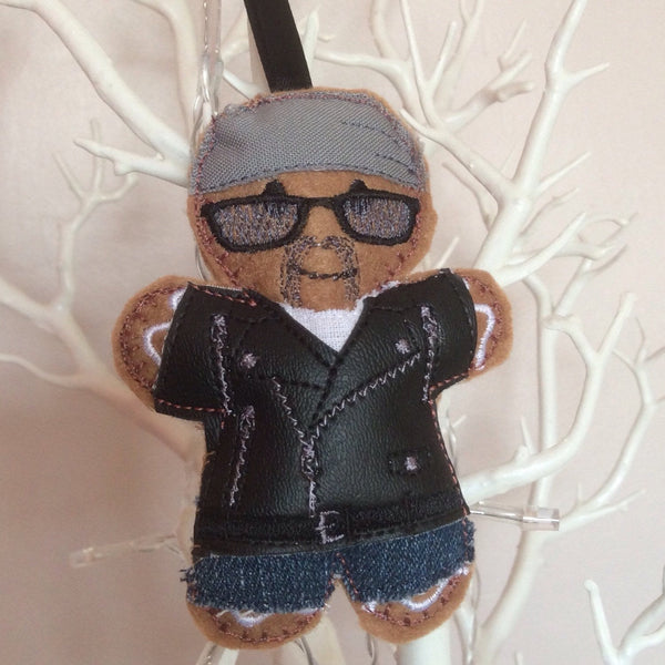 Biker gingerbread man decoration. With grey cotton headscarf, white cotton t shirt, jeans and black faux leather bikers jacket. Lightly filled with a polyester stuffing to create depth and character. Hand sewn to finish