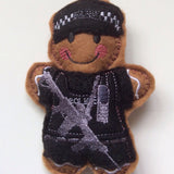 Armed police officer felt gingerbread decoration in black uniform.