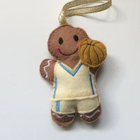 Basketball player, felt gingerbread man decoration. Lightly filled with a polyester stuffing to create depth and character. Hand sewn to finish.