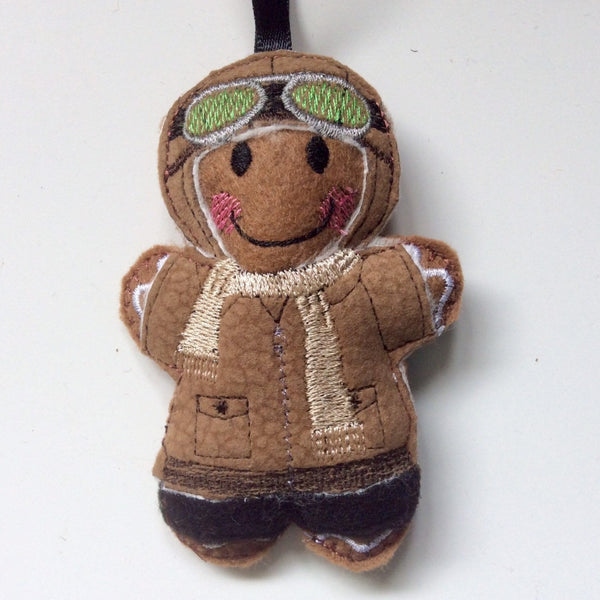 Aviator felt gingerbread decoration. Dressed in a faux leather  flying jacket and hat. Lightly filled with a polyester stuffing to create depth and character. Hand finished.