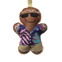 Decorative gingerbread man ornament wearing sunglasses and a colorful shirt on a white background