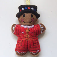 Beefeater soldier felt gingerbread man decoration. Dressed in a traditional red and black uniform.  Lightly filled with a polyester filling to create depth and character. Hand sewn to finish.