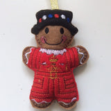 Beefeater soldier felt gingerbread man decoration. Dressed in a traditional red and black uniform.  Lightly filled with a polyester filling to create depth and character. Hand sewn to finish.