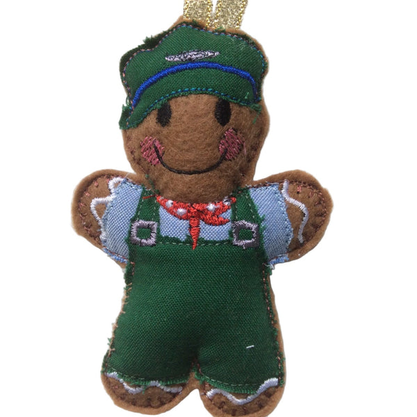 A handmade felt gingerbread man ornament in green and brown, wearing a train driver's hat and outfit, designed for Christmas tree decoration.