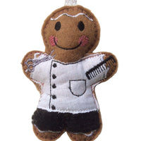 Barber gingerbread decoration. Dressed in a white cotton fabric tunic and black felt trousers. Lightly filled to create depth and character. Hand sewn to finish.