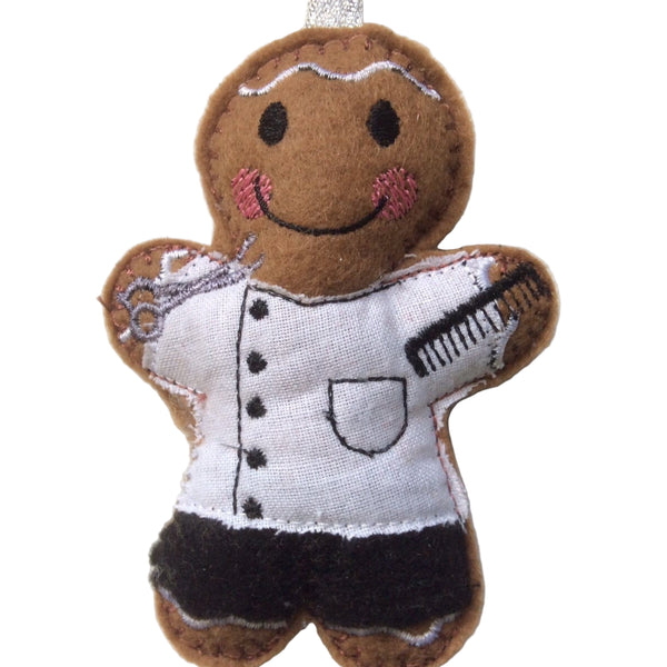 Barber gingerbread decoration. Dressed in a white cotton fabric tunic and black felt trousers. Lightly filled to create depth and character. Hand sewn to finish.