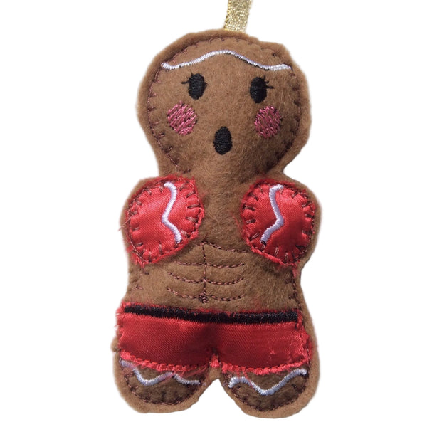 Kickboxing gingerbread decoration in red silk shorts and gloves.
