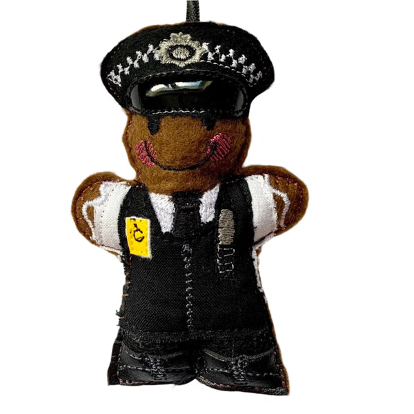 London Metropolitan police officer. Felt gingerbread man Christmas tree decoration on white background.