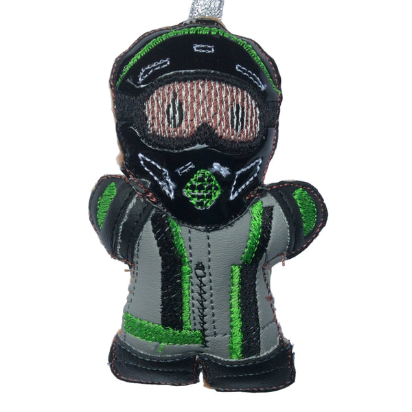 Moto GP gingerbread man decoration, dressed in black glossy vinyl helmet and grey faux leather suit, boots and gloves. on white background.