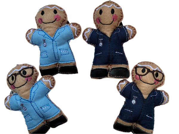 Four gingerbread nurse decorations in navy, and light blue uniforms with and without glasses, made of felt, cotton fabric and faux leather.