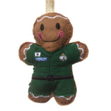 Felt gingerbread man decoration dressed in a  green paramedics uniform on a white background