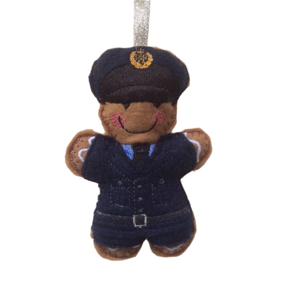 A gingerbread man decoration in a RAF dress uniform, with a hat and tie, made from felt.