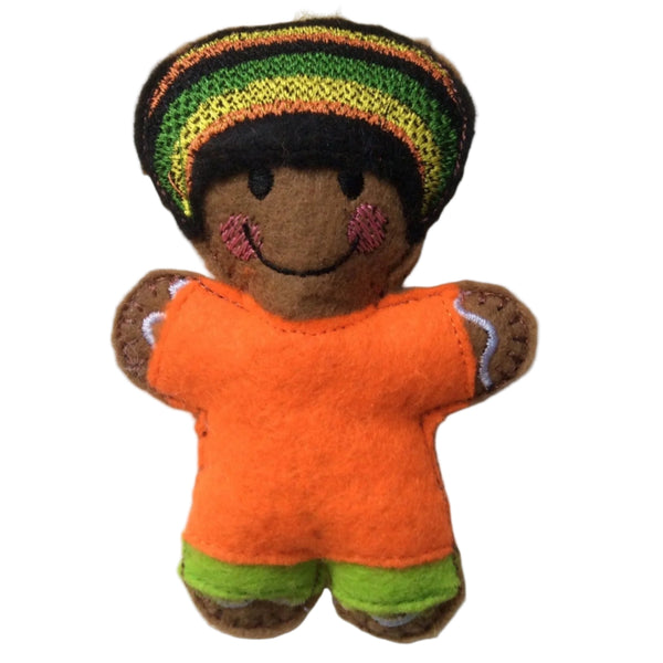 A handcrafted felt gingerbread man decoration with an orange shirt and striped hat, designed to resemble a Jamaican rasta, hanging against a white background.
