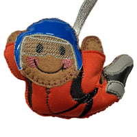 Skydiving felt gingerbread decoration wearing red suit and blue helmet. On white background.