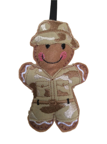 Soldier felt gingerbread decoration. Dressed in a cotton fabric embroidered camouflage uniform and sun hat Lightly filled to create depth and character.