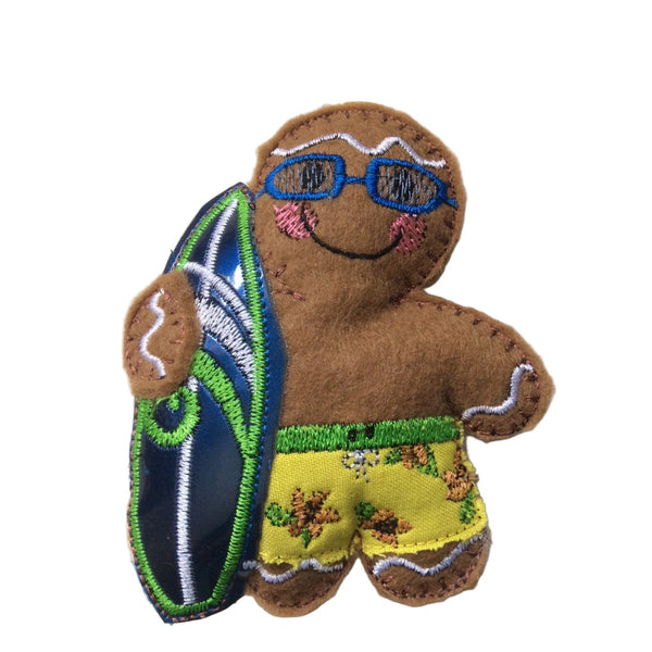 A gingerbread man surfer dude with sunglasses and a surfboard, designed as a Christmas tree ornament.