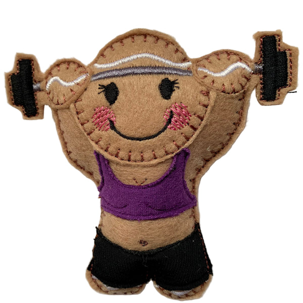 Felt gingerbread character of a woman lifting weights on a white background